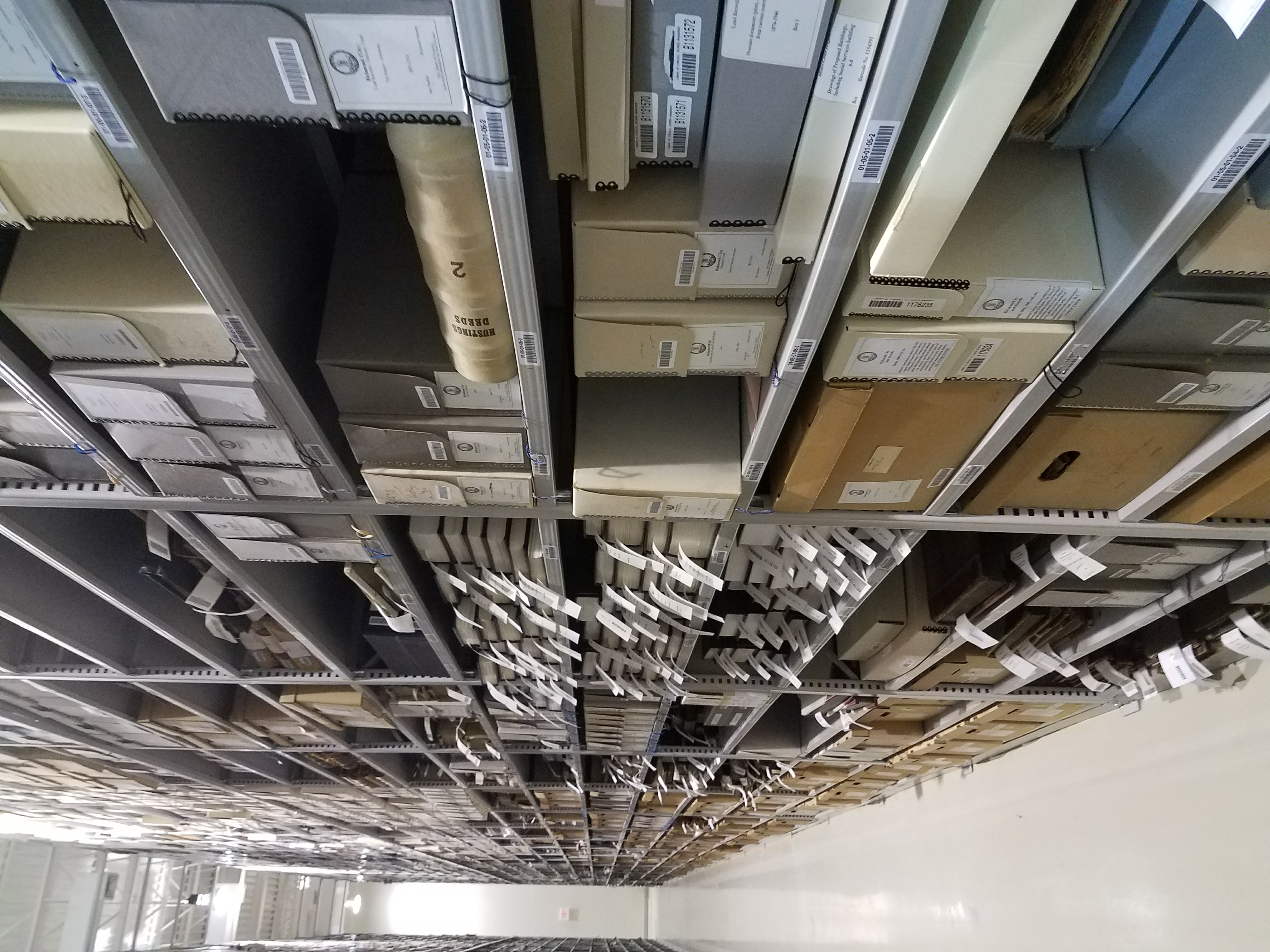 An aisle of shelving filled with boxes.